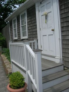 a white door and steps leading to a house