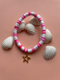 seashells and starfish necklace on pink background