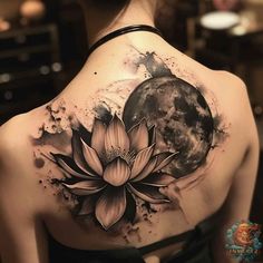 a woman's back with a lotus tattoo on it