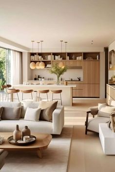 a living room filled with lots of furniture next to a kitchen and dining room table