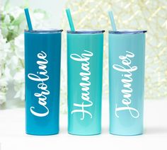 three personalized tumblers with straws sitting on a table