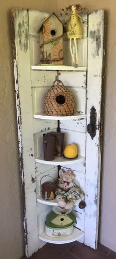 an old door is decorated with birdhouses and other things on it's shelves