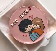 a pink cake decorated with two people and the words hbd babe on it