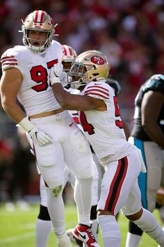 two football players congratulate each other on the field