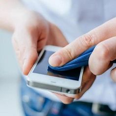 a person holding a cell phone in their hand with a blue cloth on the screen