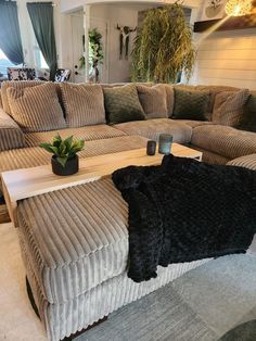 a living room filled with lots of couches and pillows on top of each other