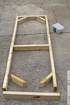 an unfinished bed frame laying on the ground