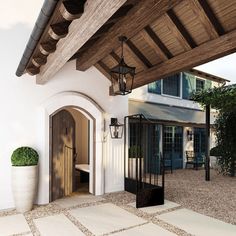 the entrance to a house with a potted plant