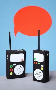 two black radio boxes sitting next to each other with an orange speech bubble above them