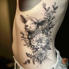 a woman's stomach with an animal and flowers tattoo on the side of her body