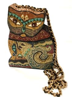 Fab unsigned Mary Francis Philippines rhinestone eyes cat purse. Body of purse is wood with many different beads, baubles, cording, etc. accenting bag. Lift lid with gold chain crossbody strap with black cording woven in it. Bag measures 8 1/4" tall x 5 3/4"  at widest bottom. Side depth is 2" and strap is 42". Condition is like new. FREE SHIPPING / TRACKING Mary Frances Handbags, Cat Purse, Mary Frances, Purse Crossbody, Beaded Purses, Wood Box, Kitty Cat, Clutch Handbag, Metal Chain