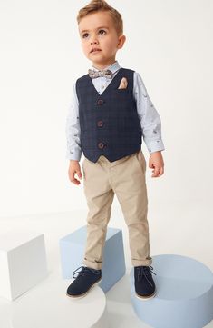 Someone is going to look so grown up in a set that features a tailored vest (complete with pocket square!) and a striped button-up embroidered in tiny trucks. A coordinated bow-tie is the party-perfect finishing touch. Vest has front button closure; is lined Shirt has front button closure 63% polyester, 34% viscose, 3% elastane vest 100% cotton shirt Machine wash, tumble dry Made in Vietnam Tailored Vest, Kids Vest, Sneaker Slippers, Blue Check, Suit Separates, Short Suit, Denim Leggings, Denim Jumpsuit, Comfortable Dress