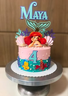 the little mermaid cake is decorated with fondant and has an edible topper that says, maya 4