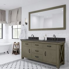 a bathroom with two sinks and a bathtub in the corner, along with a large mirror on the wall