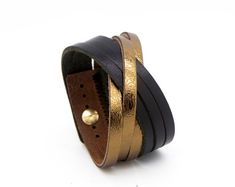 The simple design of this cuff bracelet allows the natural beauty of its rich and hearty leather to come through. Not to mention just the right touch of metallic shine!Made with a heavy cowhide leather bracelet and features an adjustable metal stud closure. Nickel-free. Fits wrists 15.5 cm – 18cm / 6" - 7 1/2" (measure wrist from point to point with no overlap) and is 3.5 cm (1 3/8") wide.View all our colour options: https://www.etsy.com/ca/shop/Rimanchik/search?search_query=orleans&order=date_d Chic Gold Cuff Bracelet With Bracelet Strap, Yellow Gold Leather Bracelets For Gift, Elegant Leather Bracelet With Gold Clasp, Yellow Gold Leather Bracelet Gift, Yellow Gold Leather Bracelet As Gift, Chic Leather Bracelet Jewelry, Luxury Gold Leather Bracelet With Adjustable Fit, Luxury Gold Leather Bracelet Adjustable, Luxury Gold Adjustable Leather Bracelet