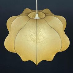 a large leaf shaped light hanging from a ceiling