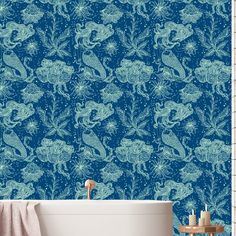 a bathroom with blue wallpaper and a bathtub