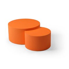 two orange round tables sitting next to each other on a white surface and one is made out of plastic