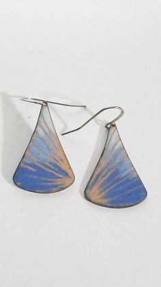 "I make these earrings by torch firing enamel onto copper. I fired transparent ckear enamel as the first layer, which looks like shiny gold and various shades of blue on top. I've drawn a pattern into the enamel before torch firing. - this technique is called sgraffito. This copper drop shape about 1 1/4\" long. They are shown on a silver plated ear wire which is nickel and lead free. Total length of earring including earwire is 1 3/4\" long. These are fun and colorful earrings. These are defini Blue Artisan Copper Earrings, Artisan Blue Copper Earrings, Blue Copper Teardrop Earrings, Blue Teardrop Copper Earrings, Artsy Blue Teardrop Earrings, Blue Teardrop Earrings With Patina, Blue Patina Earrings For Gift, Unique Blue Copper Earrings, Bohemian Blue Enamel Earrings