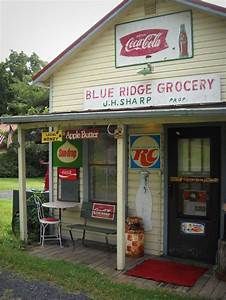 an old fashioned store with signs on the front