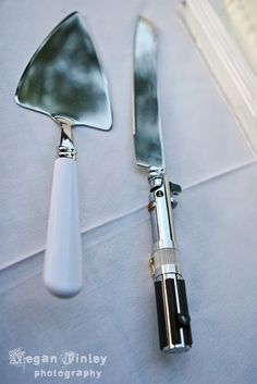 two forks and spoons sitting on top of a white table cloth next to each other