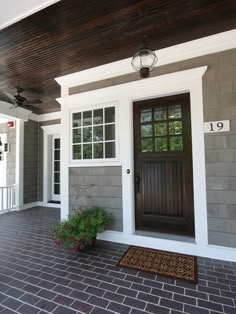 the front door of a house with two potted plants