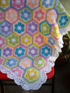 a crocheted blanket sitting on top of a chair