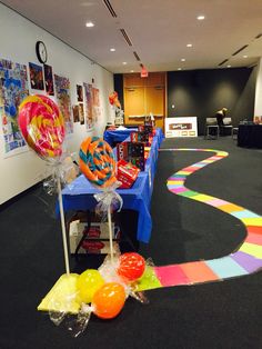 a table with balloons and streamers on it