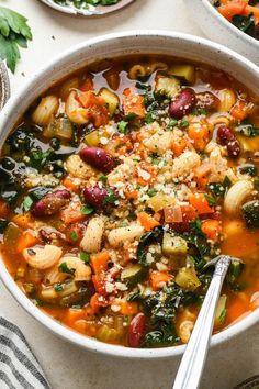 two bowls of vegetable soup on a table