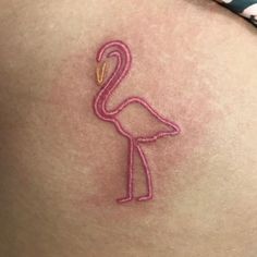 a pink flamingo tattoo on the back of a woman's stomach