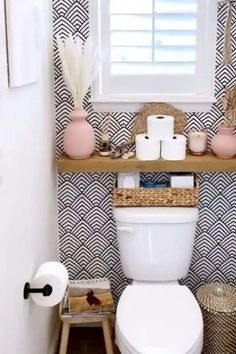 a white toilet sitting next to a window in a bathroom under a window sill