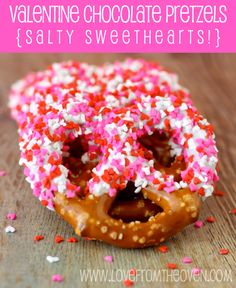 a donut with sprinkles and chocolate frosting is on the table