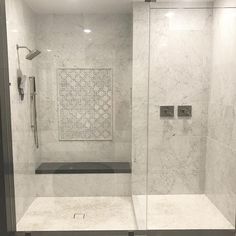 a walk in shower sitting inside of a bathroom