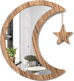 a wooden crescent mirror with a star hanging from it