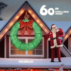 a man dressed as santa claus standing in front of a house with christmas lights on it