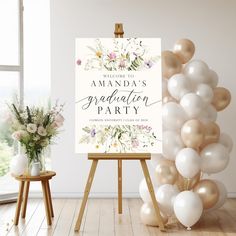 an easel with balloons and a sign that says welcome to amanda's graduation party