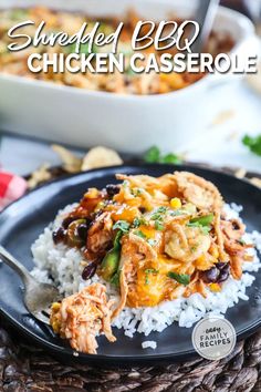 shredded bbq chicken casserole on a black plate with rice and garnish