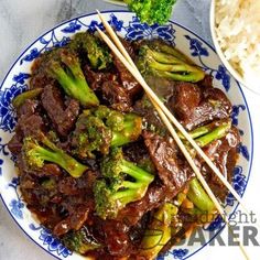 beef and broccoli stir fry with chopsticks on a blue and white plate