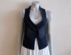 Women's Vest Blue Denim Vest Blue Jean Waistcoat Fitted Womens Sleeveless Denim Jacket  Measurements (lying flat): Length(back): 19.5"/ 49.5 cm Pit to pit: 15 3/4"/ 40 cm Waist: 15 1/4"/ 39 cm Please check measurements to insure a proper fit. Remember to allow yourself some extra room for movement. You can compare these with something from your closet that fits you well. Please convo me if you need additional measurements. Condition: Great Vintage Condition N.B. Color may slightly differ from pi Sleeveless Denim Jacket For Summer Workwear, Fitted Sleeveless Denim Vest With Pockets, Spring Dark Wash Denim Vest Top, Fitted Sleeveless Dark Wash Denim Jacket, Sleeveless Blue Denim Top For Work, Denim Sleeveless Vest For Work, Stretch Medium Wash Sleeveless Denim Vest, Sleeveless Denim Vest For Work, Dark Wash Denim Vest For Workwear, Spring