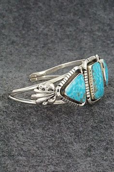 This beautiful and finely crafted turquoise and sterling silver bracelet was made by Navajo silversmith David Lopez. The back is signed David Lopez and stamped sterling.Size: 5 3/8" (will fit up to a 6 3/8" wrist)Gap: 1"Width: 1"Cuff Width: 1/4"Free shipping on all orders! We ship with USPS and always include tracking. All orders ship within a day of payment.Returns are accepted up to 30 days after you receive your order. Just send us a message. Our shop offers cash back or store credit. The item must be returned in new condition. Adjustable Southwestern Turquoise Sterling Silver Bracelet, Southwestern Turquoise Inlay Sterling Silver Bracelet, Unique Turquoise Nickel-free Bracelets, Unique Turquoise Nickel-free Cuff Bracelet, Southwestern Turquoise Nickel-free Jewelry, Native American Jewelry, Turquoise Sterling Silver, Free Jewelry, Sterling Silver Bracelets