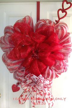 a heart shaped wreath hanging on the front door