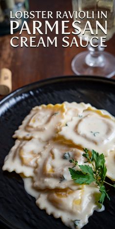 a black plate topped with mashed potatoes covered in gravy