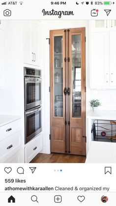 an instagram photo of a kitchen with two ovens and a large wooden door