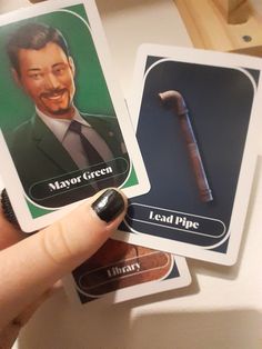 a person holding two cards with an image of a hammer and a man in a suit