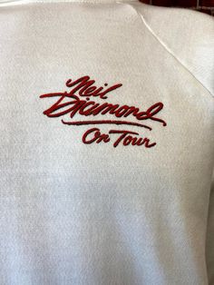 "Vintage 80's unisex Neil Diamond 1986 Live at the Greek Theatre in Los Angeles tour concert original sweat-shirt size large. Excellent condition with no stains or holes, 50% cotton 50% polyester. Made in Usa. Please, check carefully the measurements, photos and description of the article before buying it, we do not accept changes or returns. Measuraments lying face down from outside: 21\" Across chest underarm to underarm. 27\" Sleeve length from collar seam to cuff. 24 1/2\" Long, front middle Vintage Cotton Sweatshirt With Embroidered Logo, Retro Crew Neck Sweatshirt For Concerts, Vintage Cotton Sweater With Embroidered Graphics, Vintage Cotton Sweatshirt With Embroidered Graphics, Band Logo Crew Neck Sweatshirt For Concert, Neil Diamond, Velvet Jacket, Pink Sweatshirt, Grey Fashion