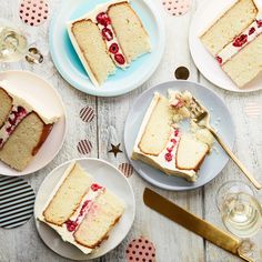 a table topped with slices of cake next to plates filled with desserts and forks