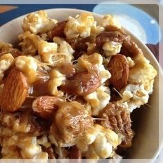 a bowl filled with nuts and almonds on top of a table