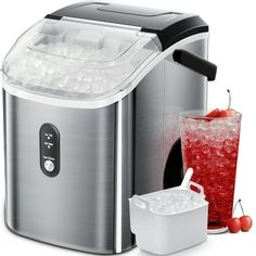 an image of a juicer and ice buckets with drinks on the table in front of it