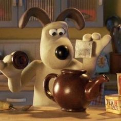 a cartoon dog is holding a tea pot