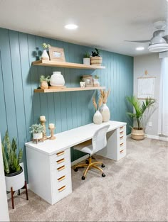 a home office with shelves and plants on the wall, along with two desks